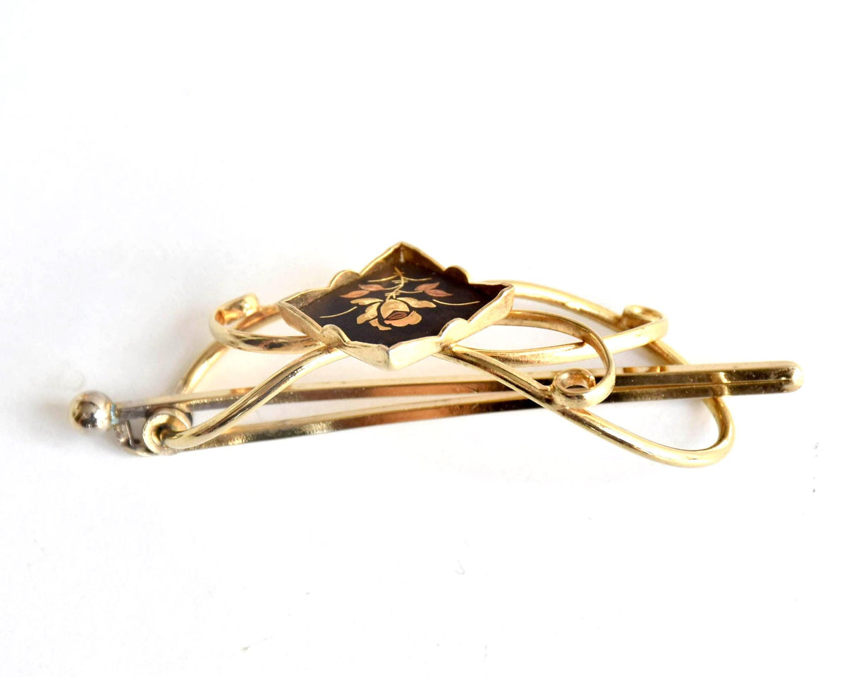 Floral Zogan Damascene Hair Ornament Gold And Black side view showing the curved shape of the metal