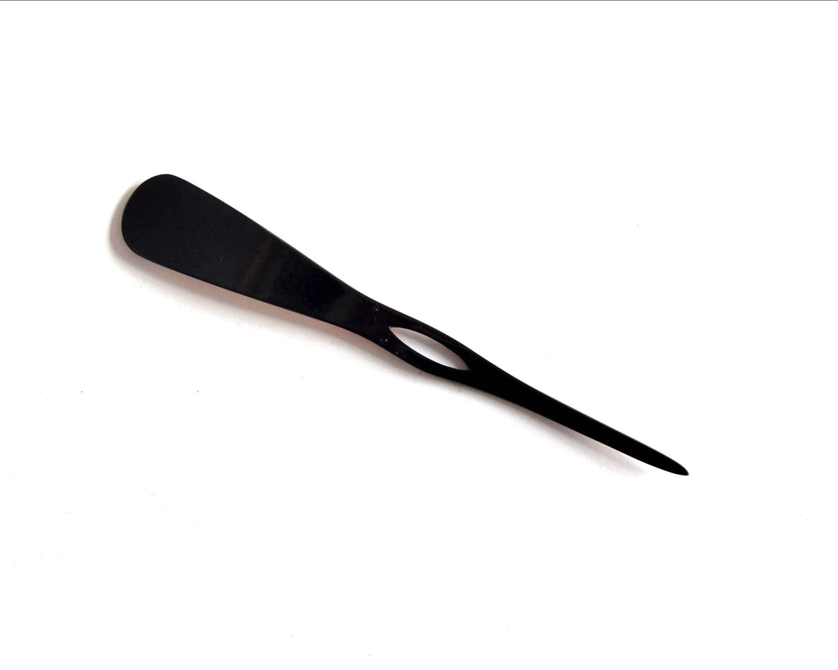 Red lacquered kanzashi hair accessory showing the plain black back side