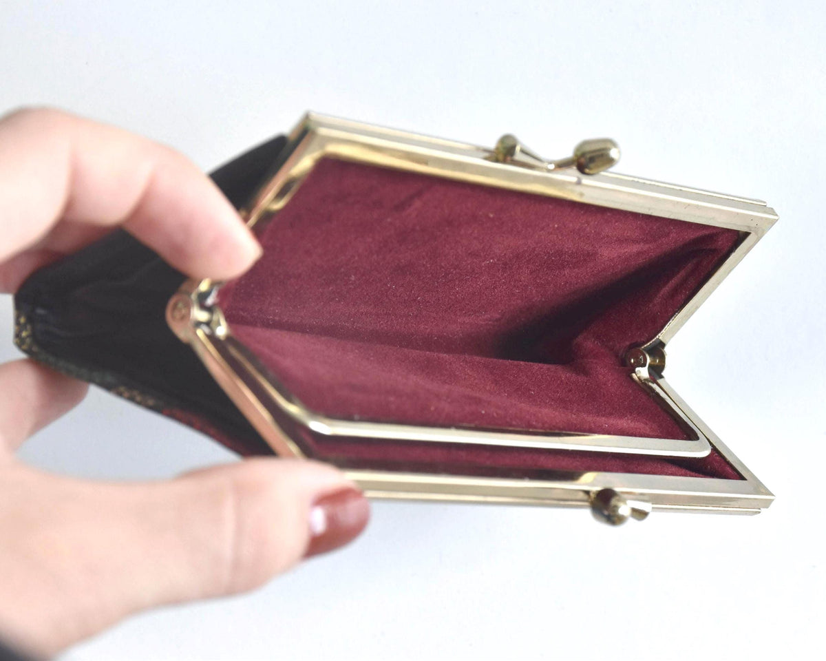 Green Oshima Tsumugi Silk Gamaguchi Coin Purse open to show the burgundy interior lining.