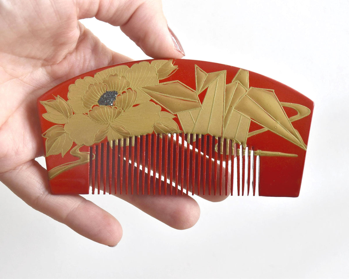 Red Lacquer Kanzashi Set hair accessories comb held in hand showing size