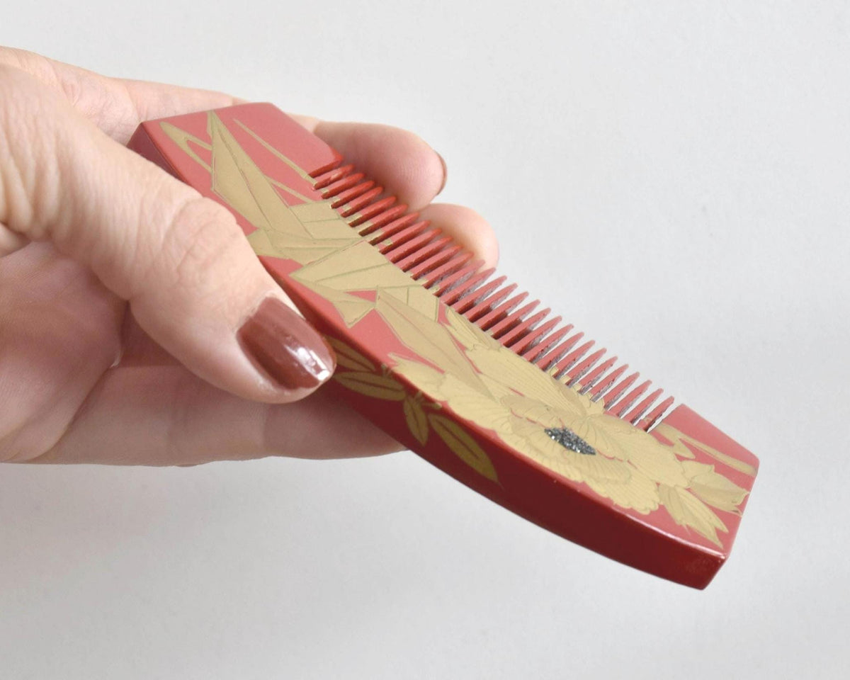 Red Lacquer Kanzashi Set hair accessories comb held in hand at angle