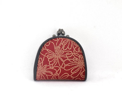 Inden deerskin coin purse showing the back side with red deerskin and detailed lacquer stenciling