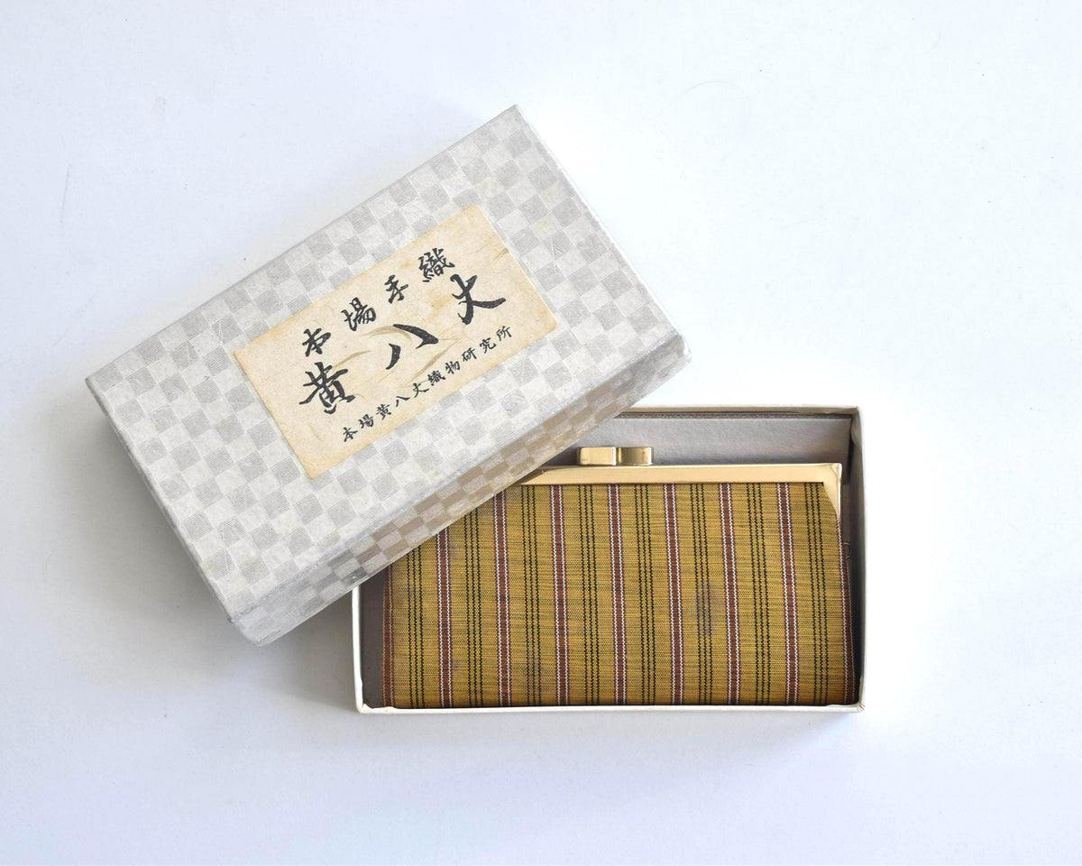 Kihachijo silk coin purse inside storage box with Japanese calligraphy label