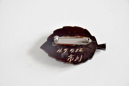 Back of Ainu leaf brooch showing metal clasp signature and 1991 date