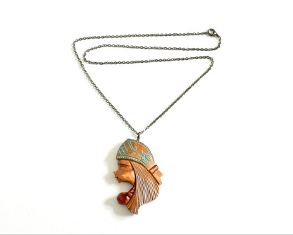 Ainu double-sided wooden pendant necklace displayed flat with its full dark metal chain against a white background