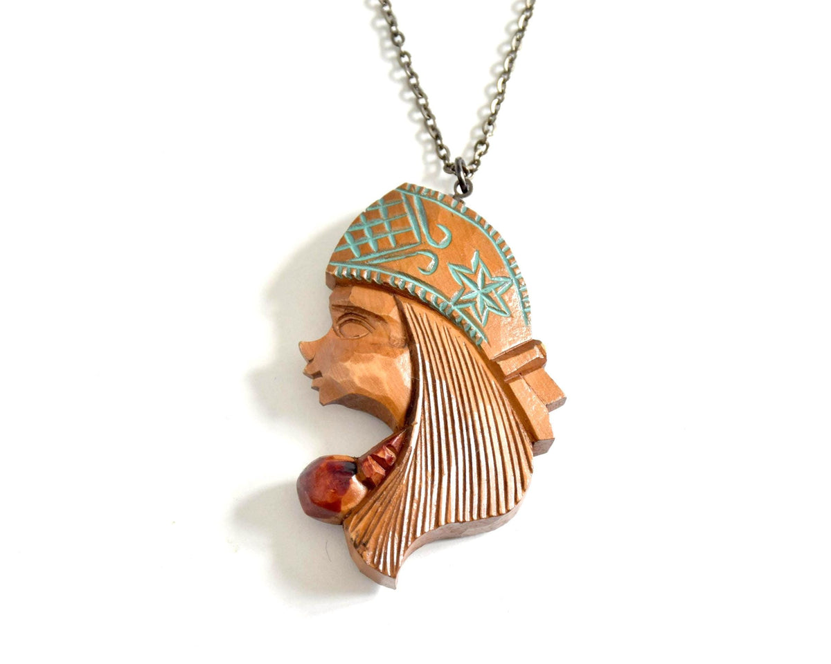 Ainu Double-Sided Female Face Wooden Pendant Necklace from Hokkaido with chiseled profile and turquoise-blue pigments