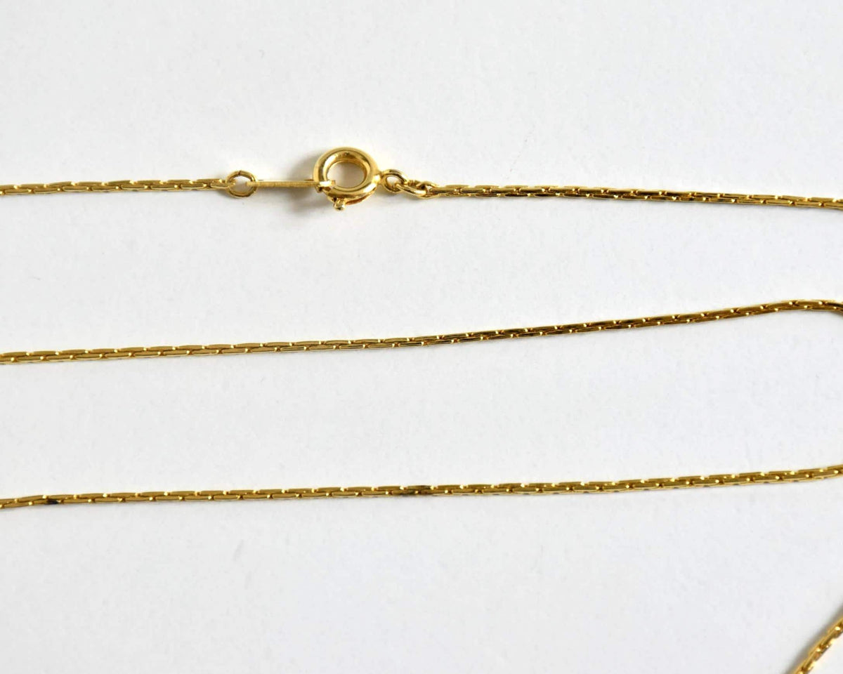 Ainu handcarved wood pendant necklace close up of the gold-tone chain clasp
