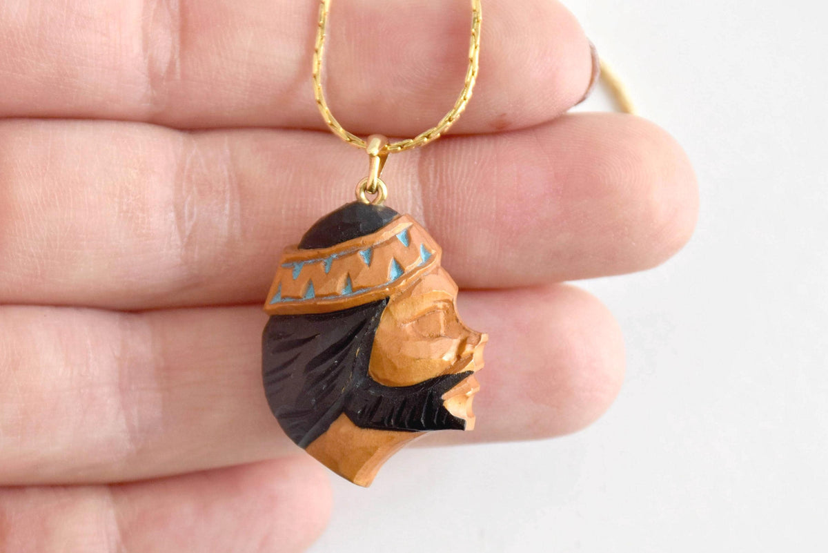 Ainu handcarved wood pendant necklace showing the bearded man profile portrait