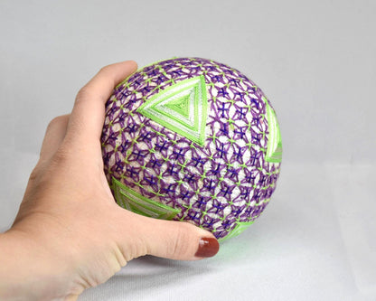 Hand-Embroidered Japanese Temari Ball Folk Art shown next to a hand for scale.