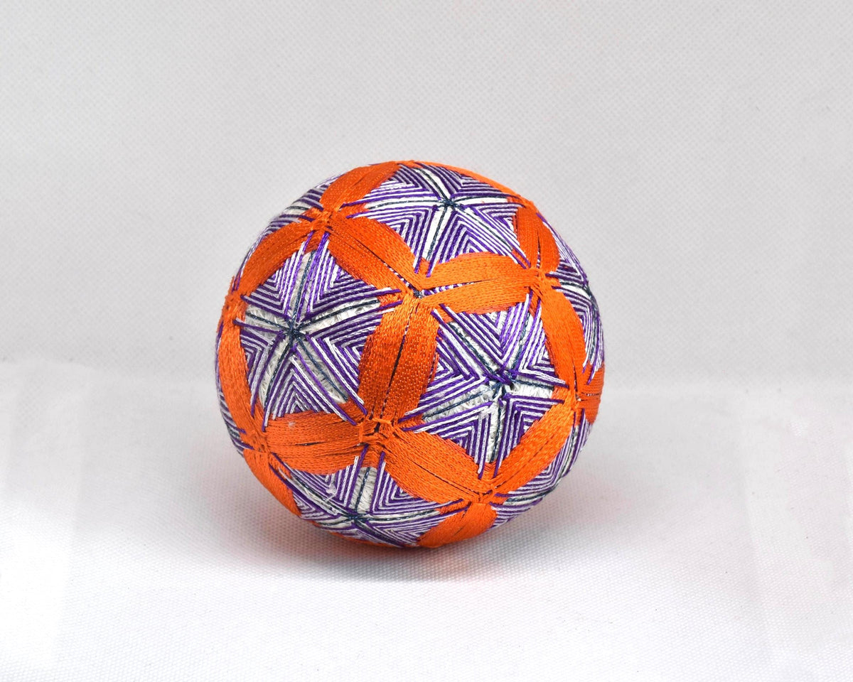 Hand-Embroidered Temari Ball Orange And Purple table scatter with intricate stitched geometric patterns