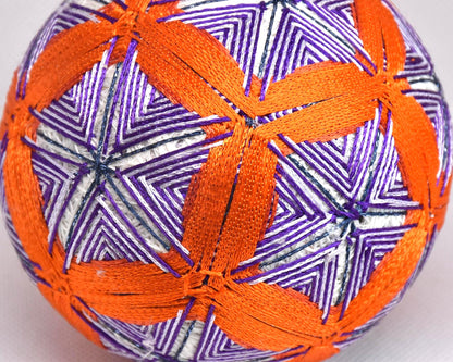 Hand-Embroidered Temari Ball Orange And Purple table scatter close up showing colourful thread stitching