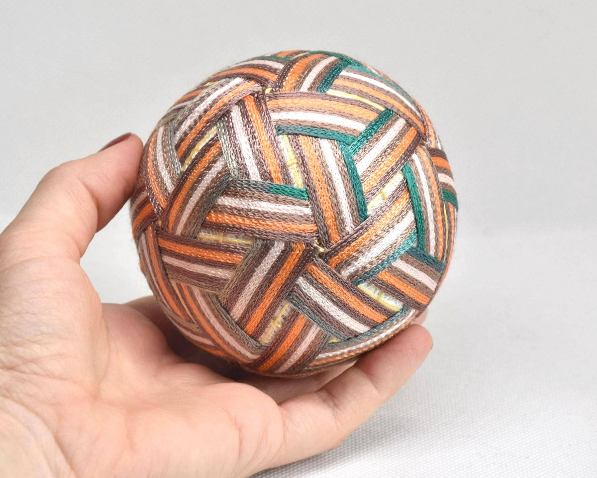 Hand-Embroidered Japanese Temari Ball folk art table scatter displayed next to a hand to show scale