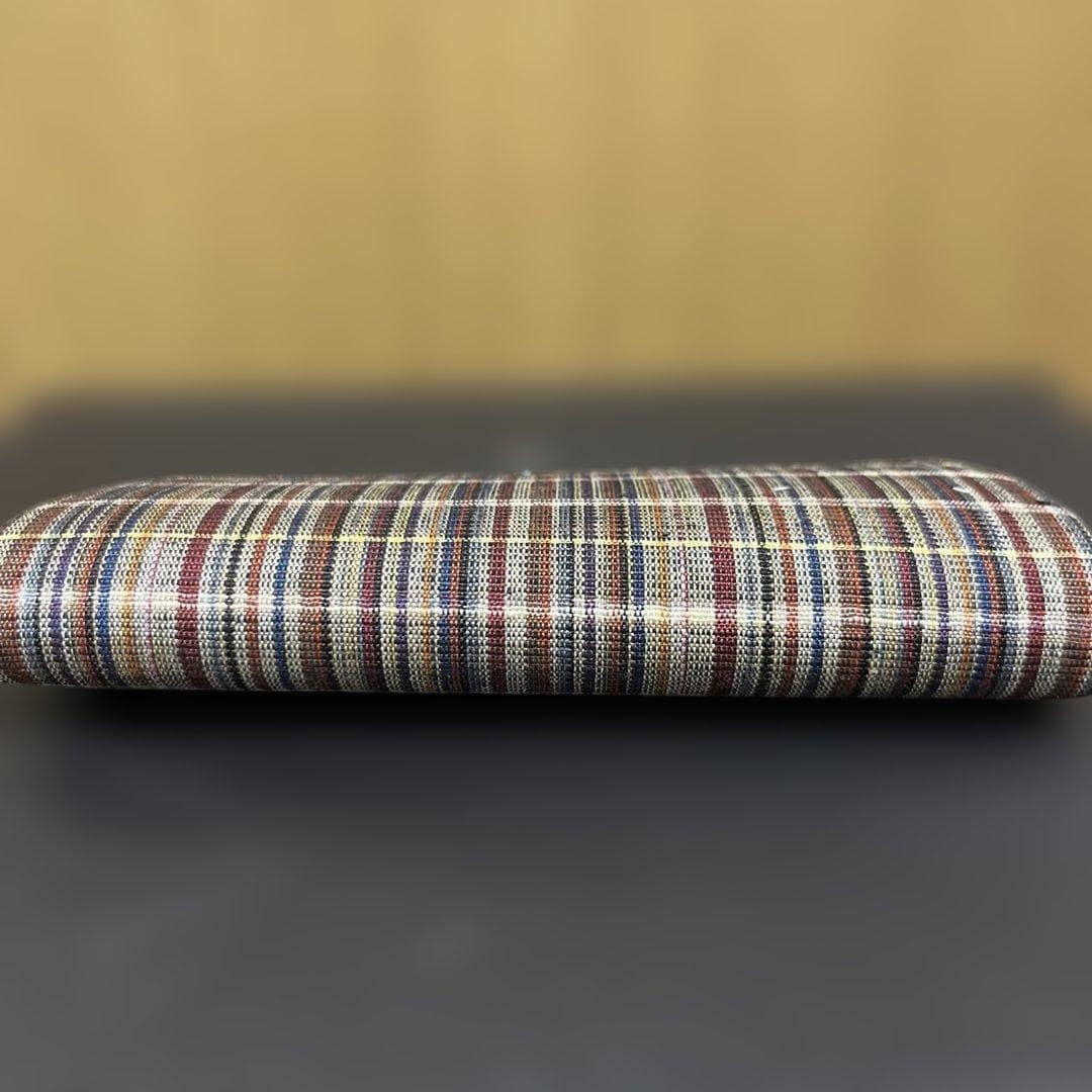 Ueda Tsumugi silk coin purse viewed from the back showing continuous striped textile