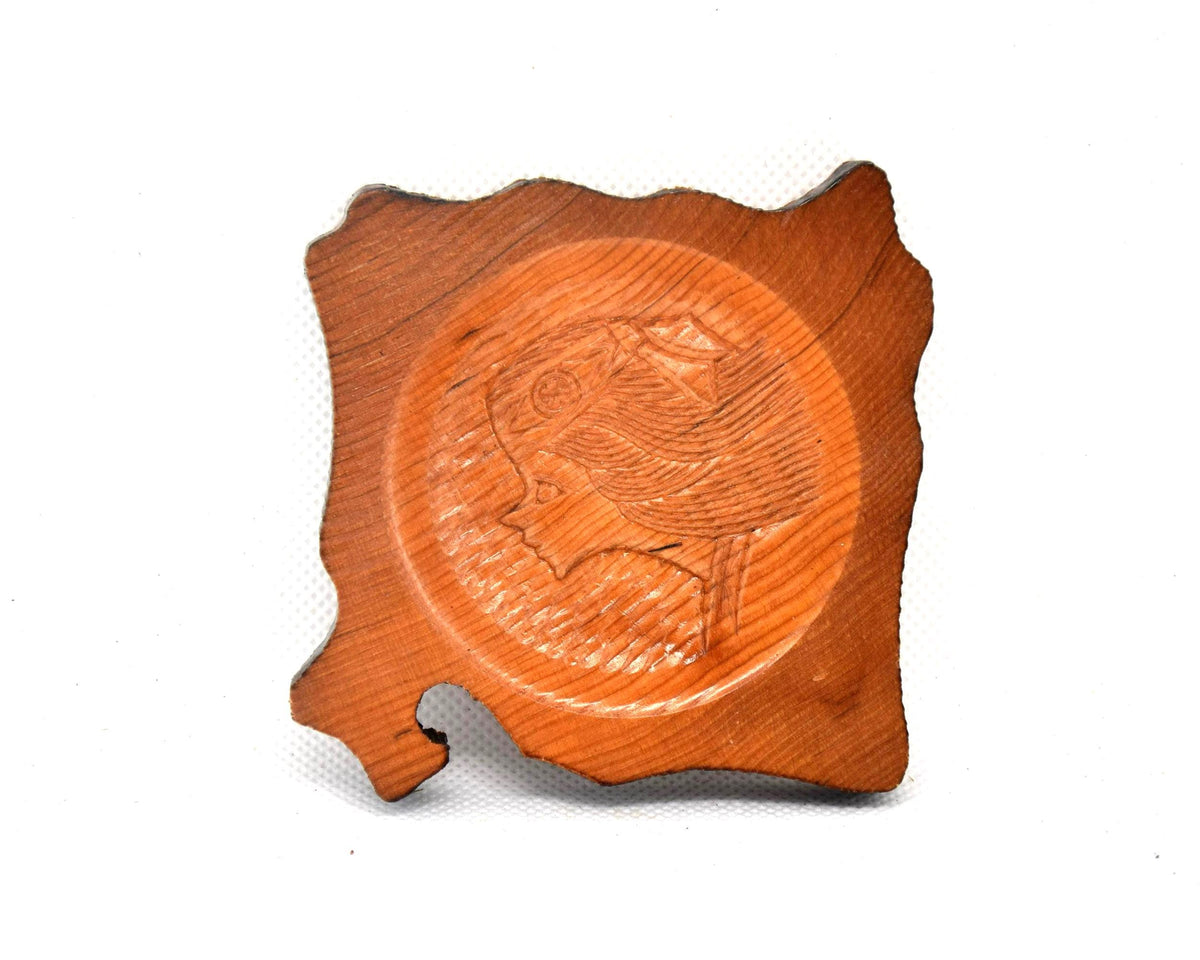 Ainu wooden coaster featuring the intricate profile carving of a woman