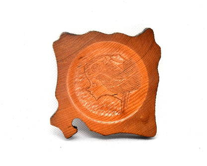 Ainu wooden coaster featuring the intricate profile carving of a woman