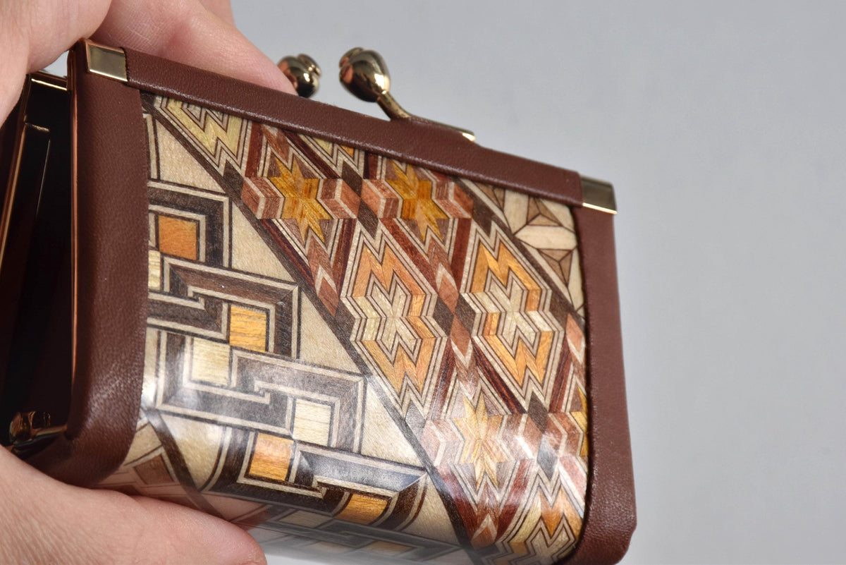 Yosegi Zaiku coin purse held in hand showing intricate star and block pattern