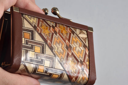 Yosegi Zaiku coin purse held in hand showing intricate star and block pattern