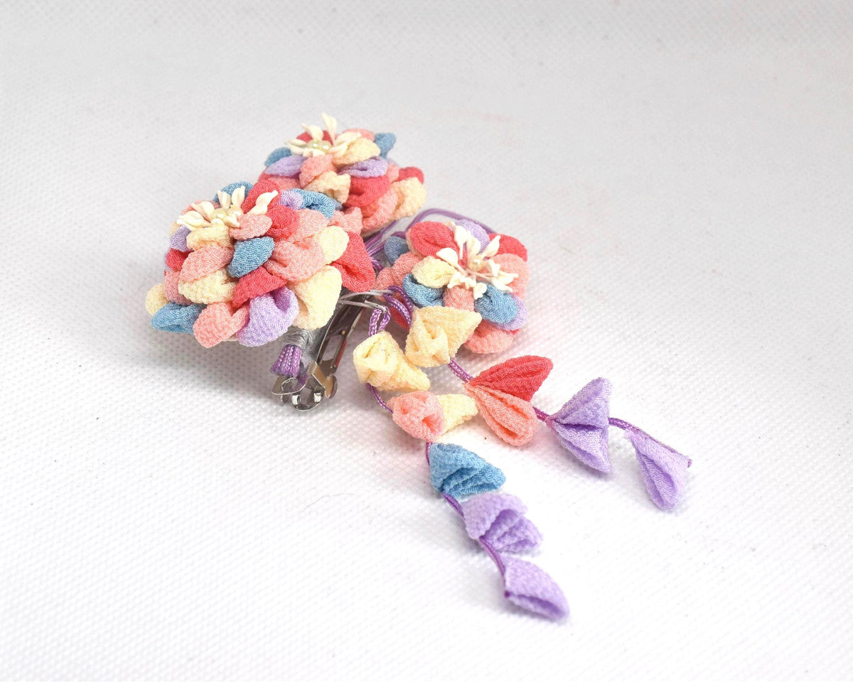 Chirimen Crepe Tsumami-Zaiku Floral Kanzashi Barette shown from the side with dangling petal accents