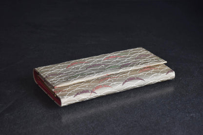 Shiseido Japanese Kimono Clutch With Traditional Weaves resting on a dark surface