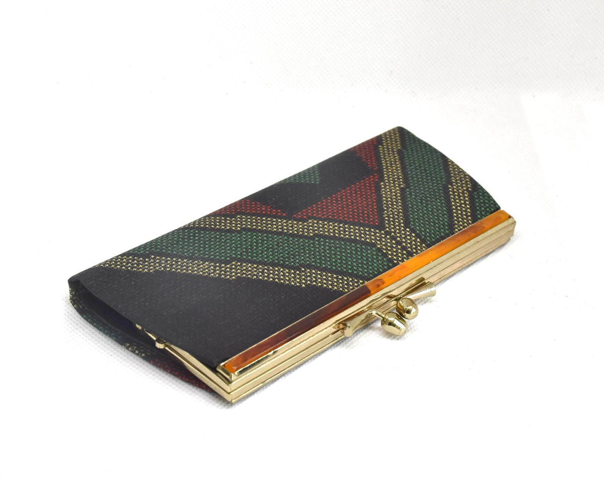 Green Oshima Tsumugi Silk Gamaguchi Coin Purse angled view of the side and clasp.