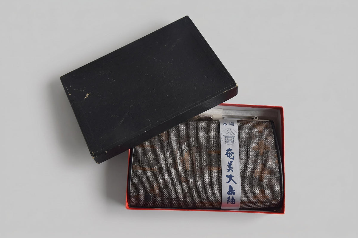 Amami Oshima Tsumugi silk clutch presented inside its original storage box