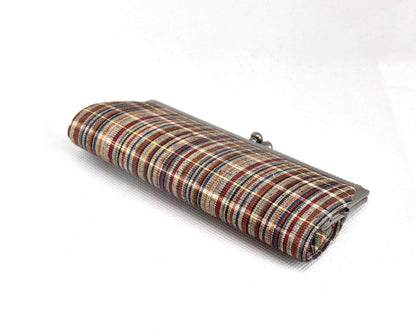 Ueda Tsumugi silk coin purse angled view highlighting the woven texture and metal frame