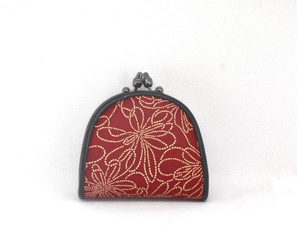 Inden deerskin coin purse featuring a red floral lacquer pattern and dark metal gamaguchi clasp