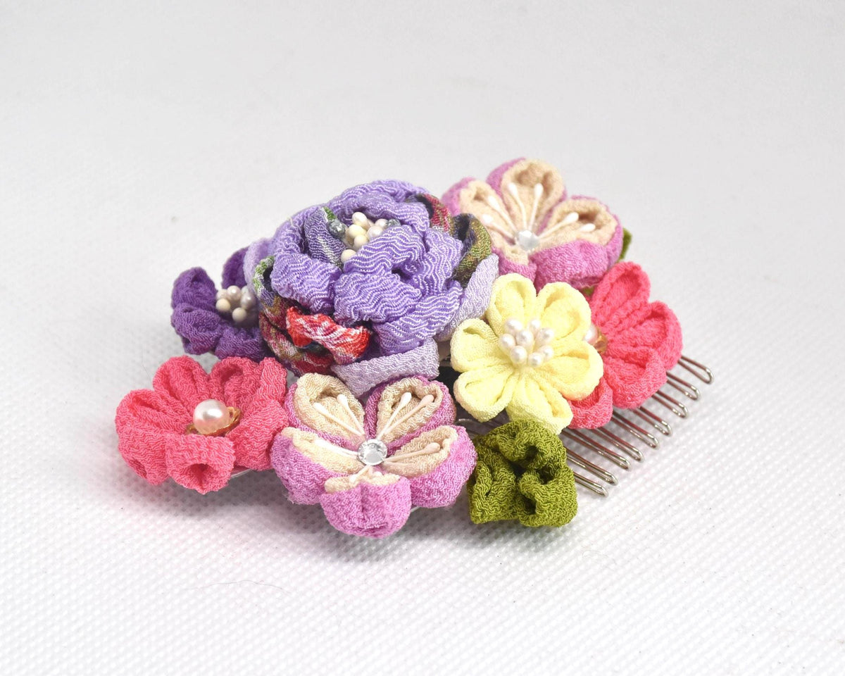 Tsumami-Zaiku Chirimen Crepe Flower Hair Comb displayed on a flat surface from a low angle