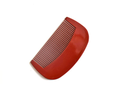 Toyama decorative Japanese hair comb angled to highlight the smooth polished lacquer surface