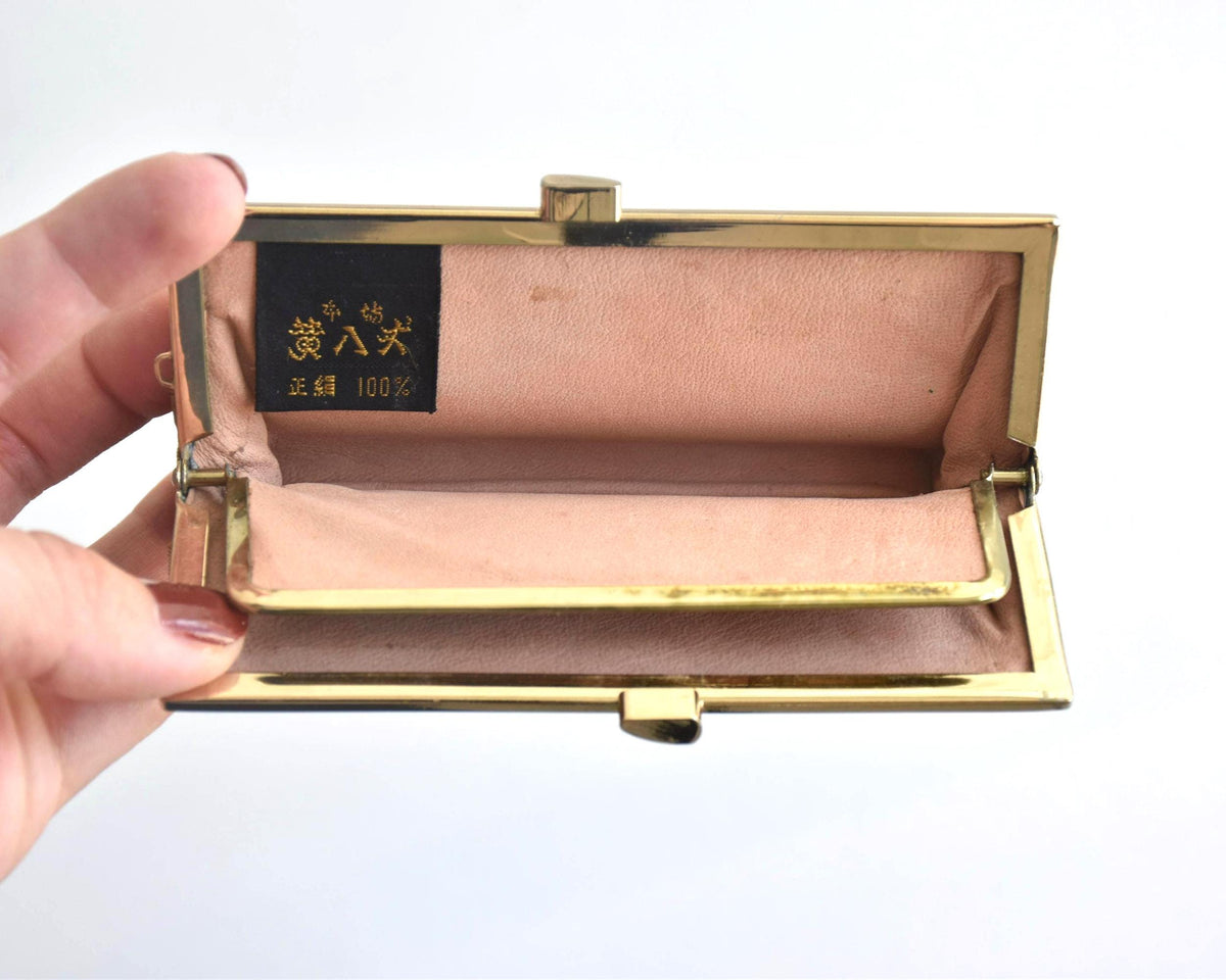 Kihachijo silk coin purse open showing peach-colored interior and label with Japanese text