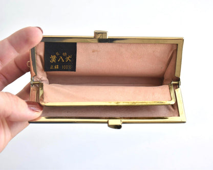 Kihachijo silk coin purse open showing peach-colored interior and label with Japanese text