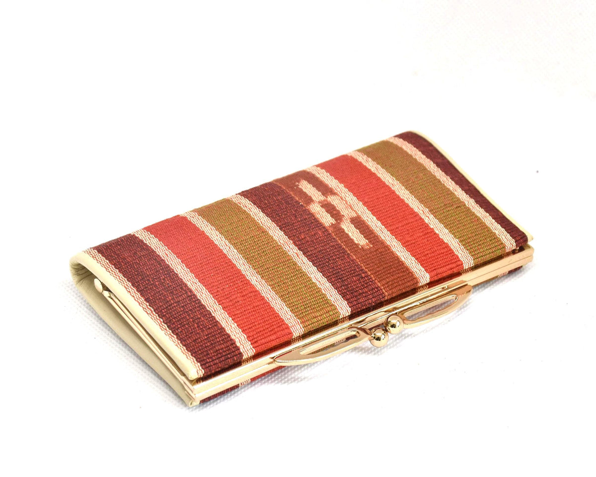 Yaeyama Minsa-Ori coin purse angled view highlighting the gold-tone metal kiss-lock frame