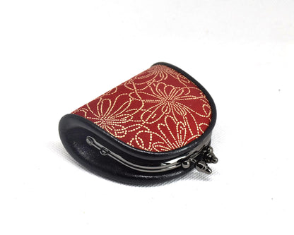 Inden deerskin coin purse angled view highlighting the curved metal frame and structure
