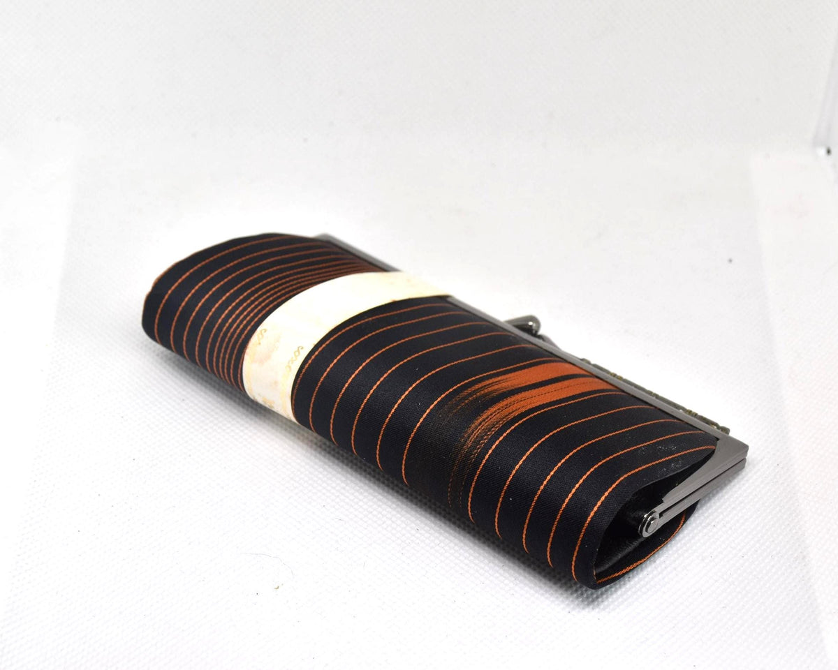 Nishijin-Ori Silk Gamaguchi Purse Black Copper Stripe side angle view of the clutch