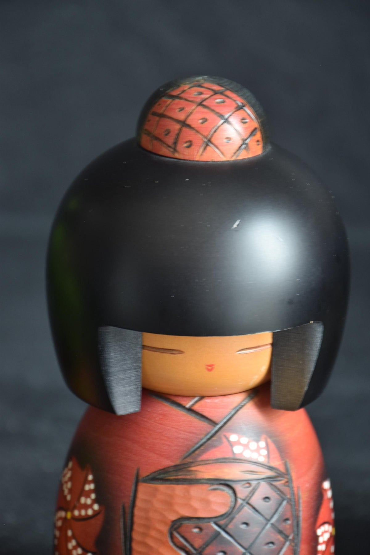 Masae Fujikawa kokeshi doll close-up of minimalist face and cross-hatched hair bun