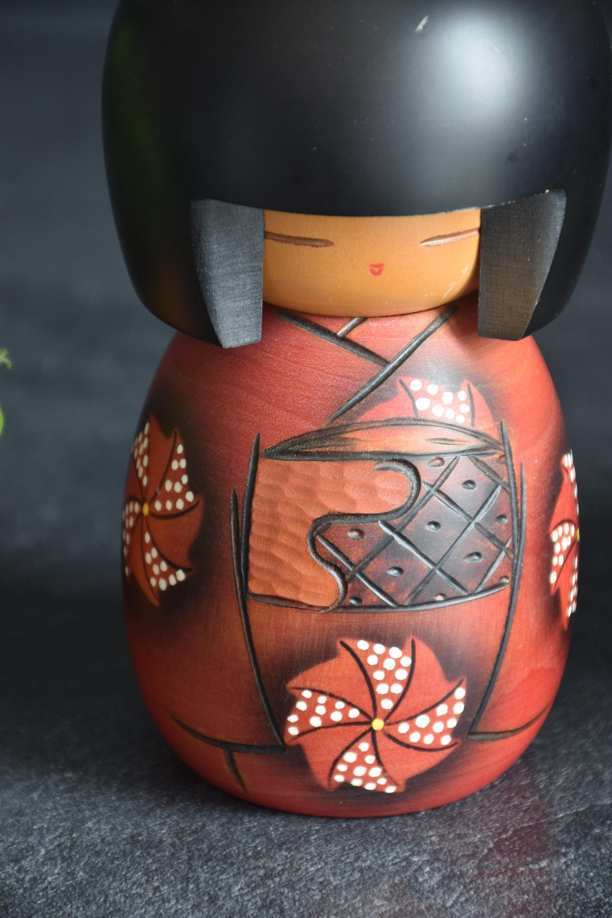 Masae Fujikawa kokeshi doll close-up of face and textured obi sash on kimono