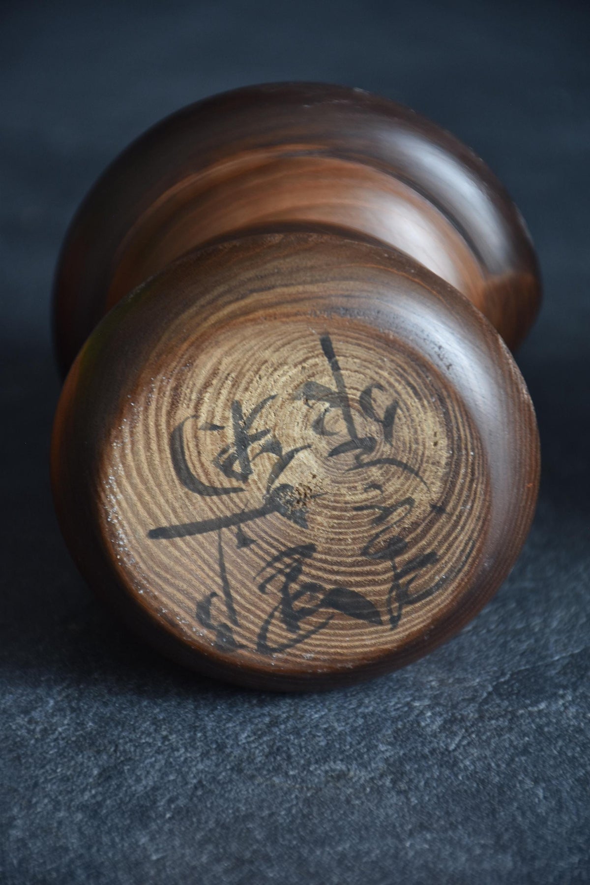 Takeda Masashi kokeshi doll showing base with artisan signature