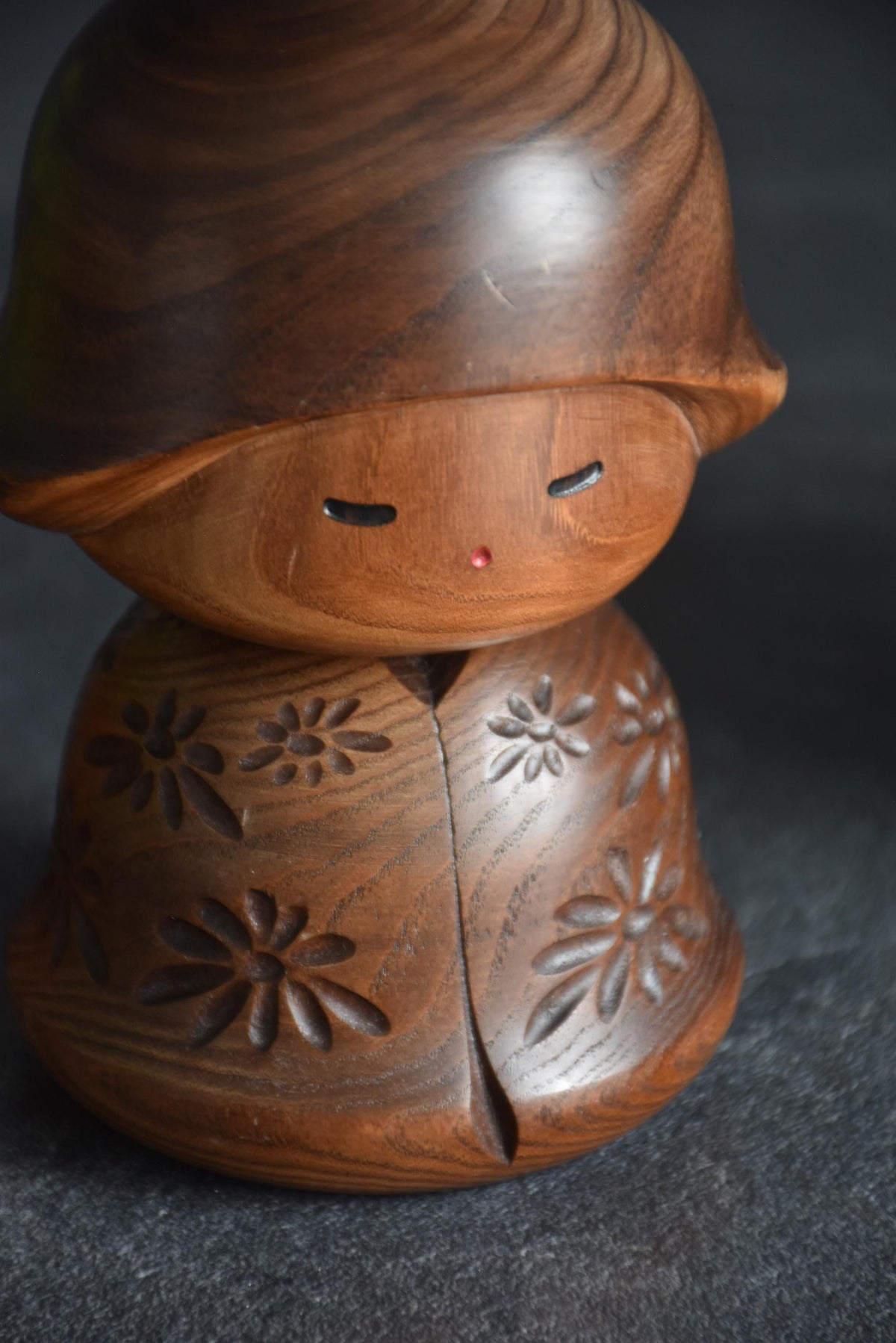 Takeda Masashi kokeshi doll showing face with closed eyes