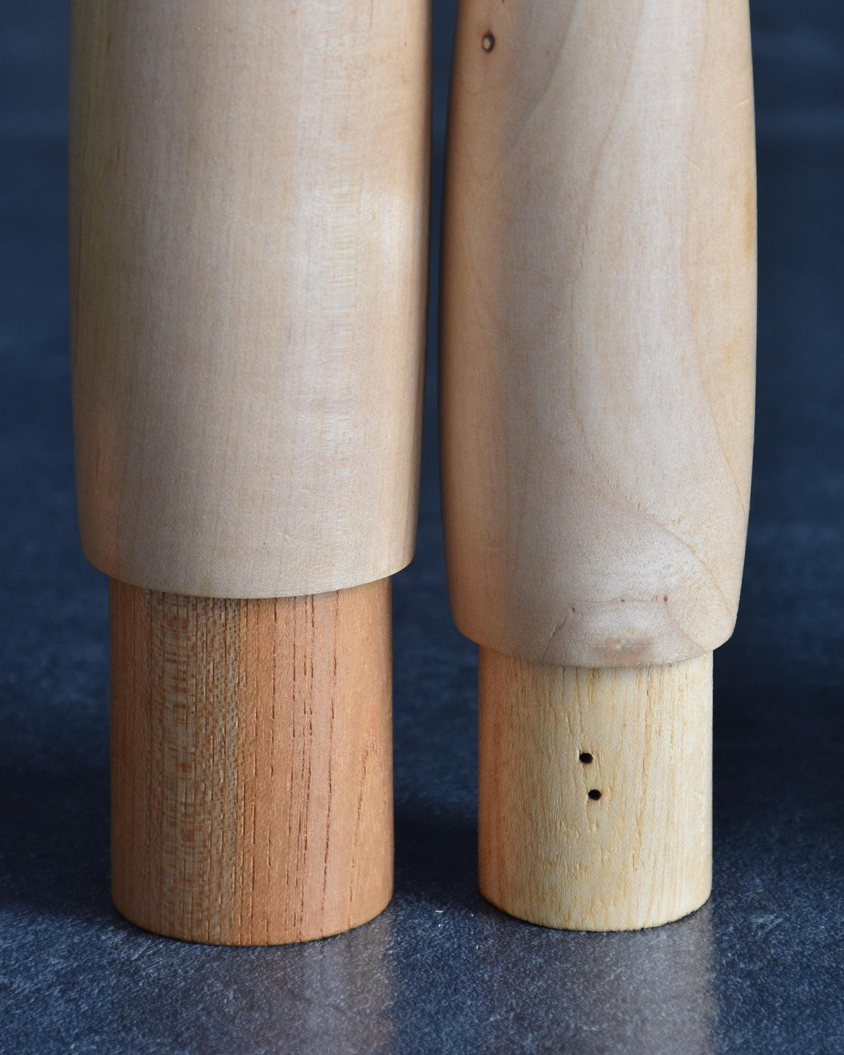 Shido Shozan kokeshi pair close-up showing tiny holes on smaller base