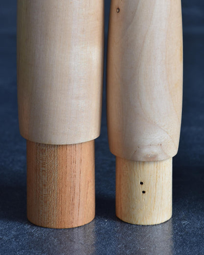 Shido Shozan kokeshi pair close-up showing tiny holes on smaller base