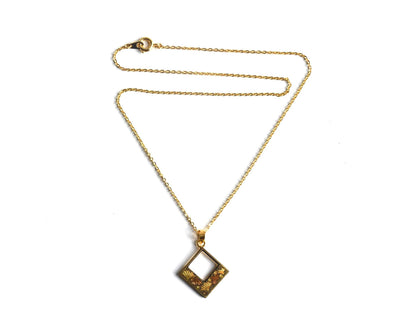 Floral Zogan Damascene Inlay Gold Necklace laid out flat with chain and pendant