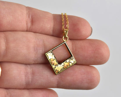 Floral Zogan Damascene Inlay Gold Necklace pendant held in palm to show size