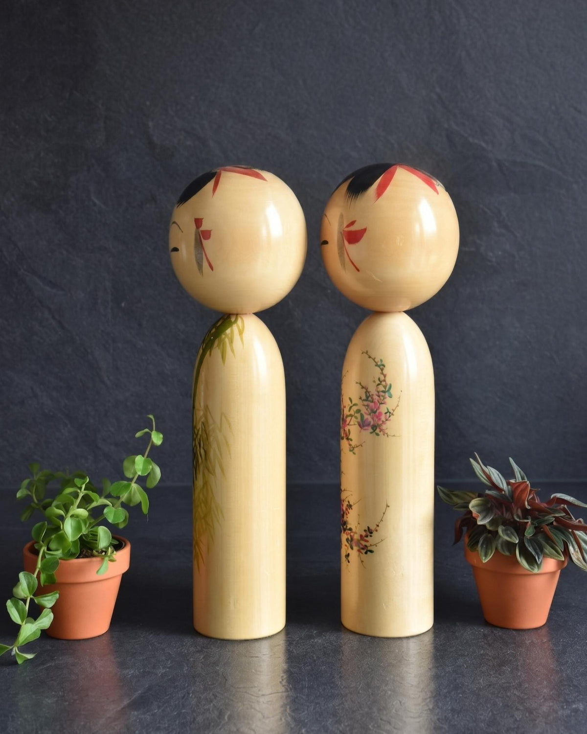 Pair of Japanese kokeshi dolls bamboo and floral motif full view