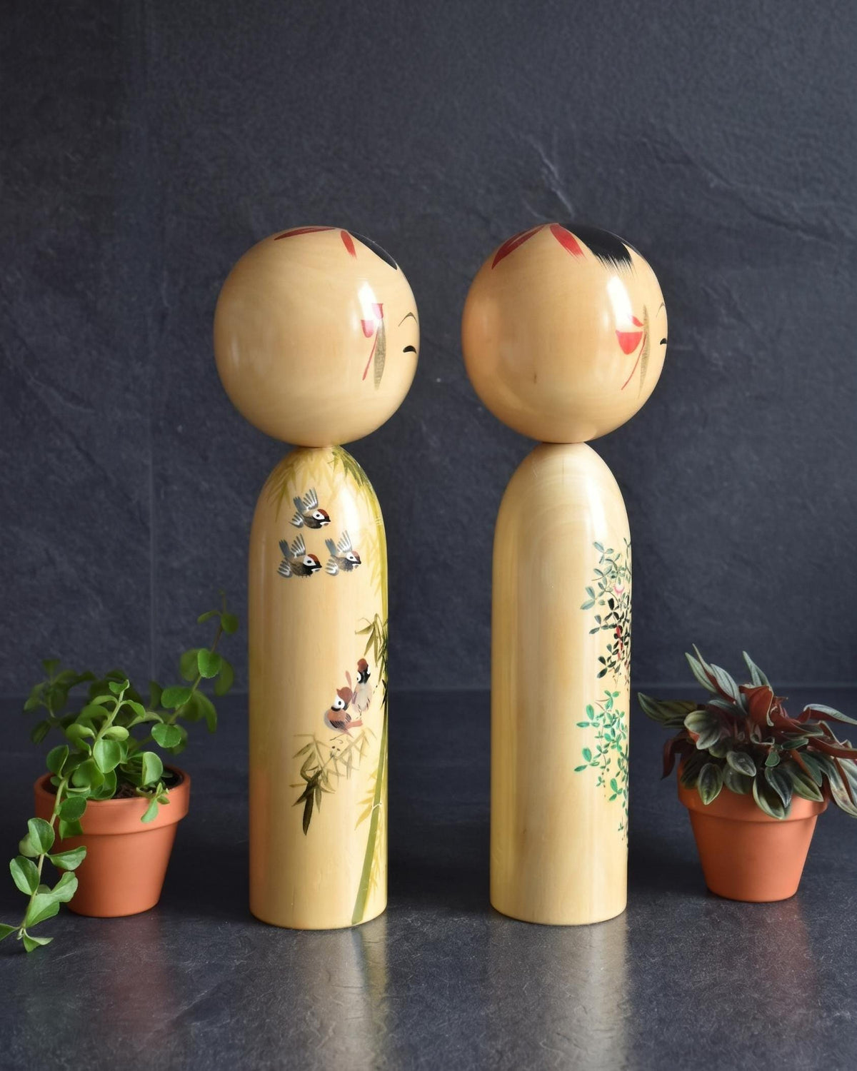 Pair of Japanese kokeshi dolls bamboo and floral motif showing body patterns