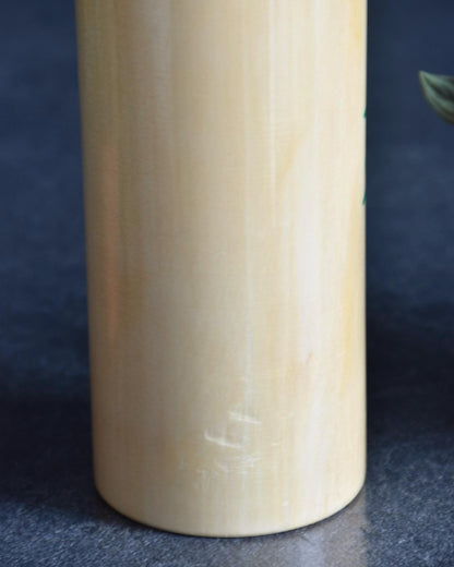 Pair of Japanese kokeshi dolls bamboo and floral motif lower body surface