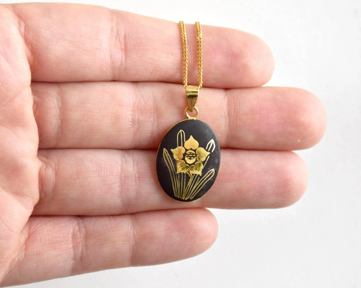 Japanese Zogan Floral Pendant Necklace Gold Inlay shown resting on a hand for scale
