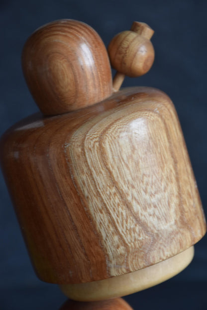 Masuo Sato kokeshi doll close-up of the carved hair ornament and tilted bob top