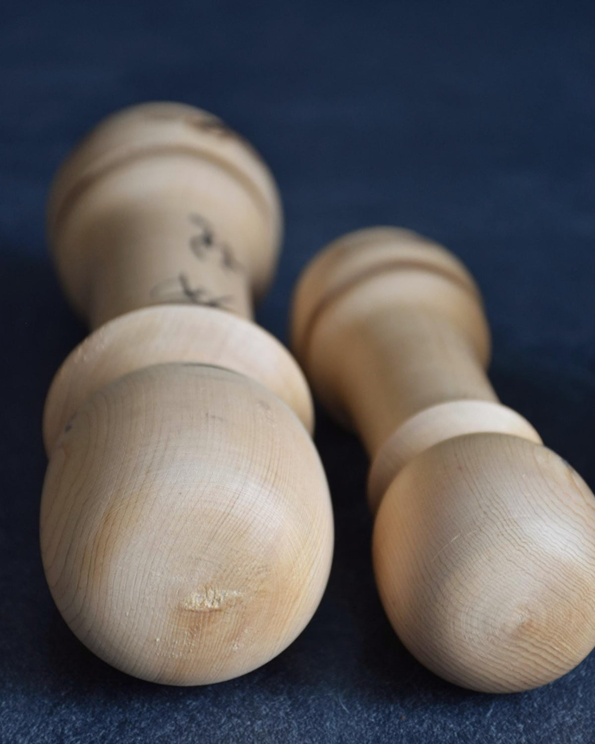 Isamu Ise kokeshi dolls top down view showing the rounded wooden crown grain.