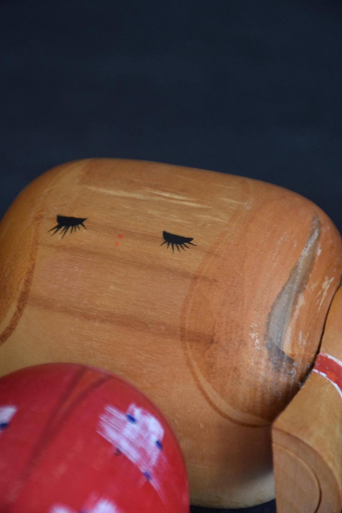 Hajime Miyashita kokeshi doll face close up with closed eyes