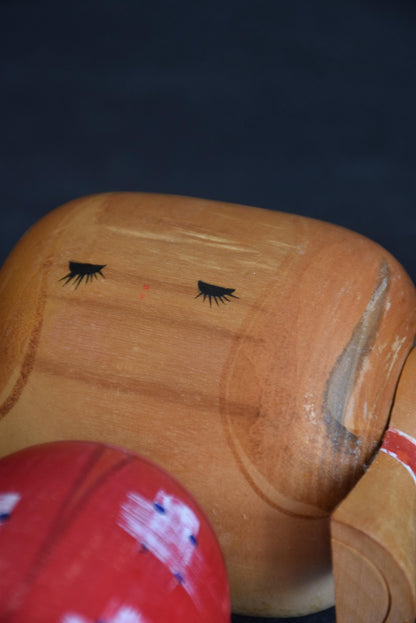 Hajime Miyashita kokeshi doll face close up with closed eyes